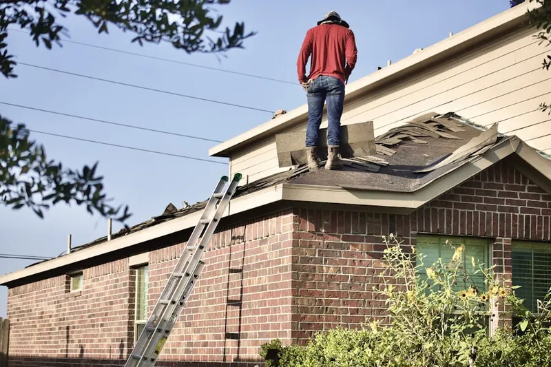Professional roofer working on a residential roof in Lafayette Park
